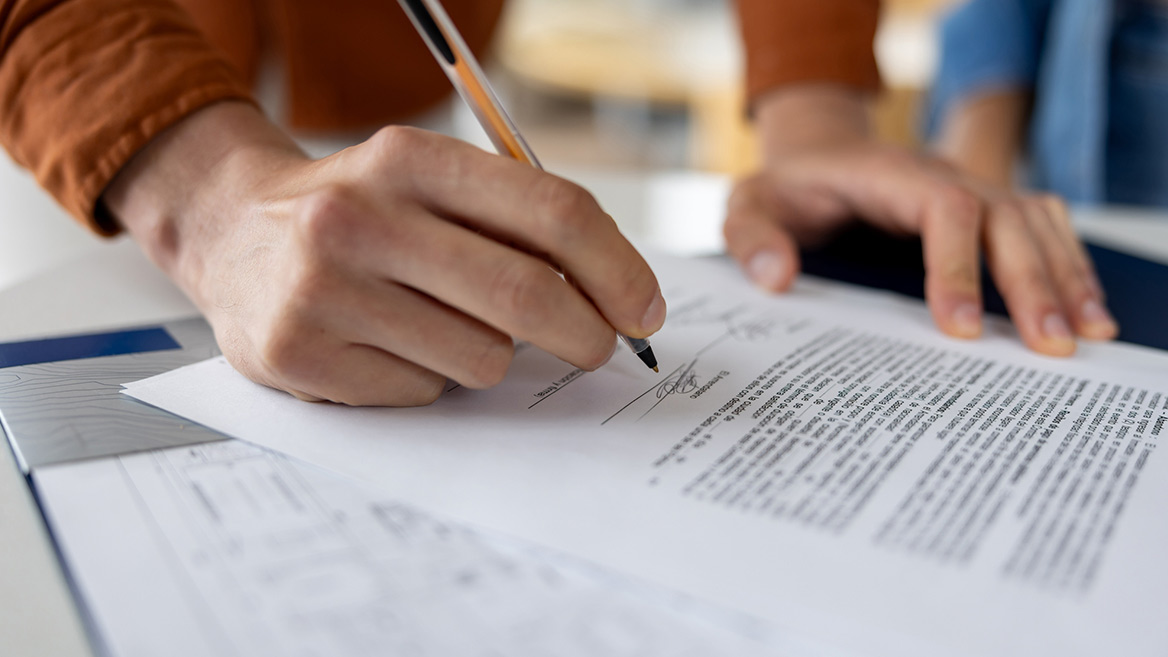 person signing a form