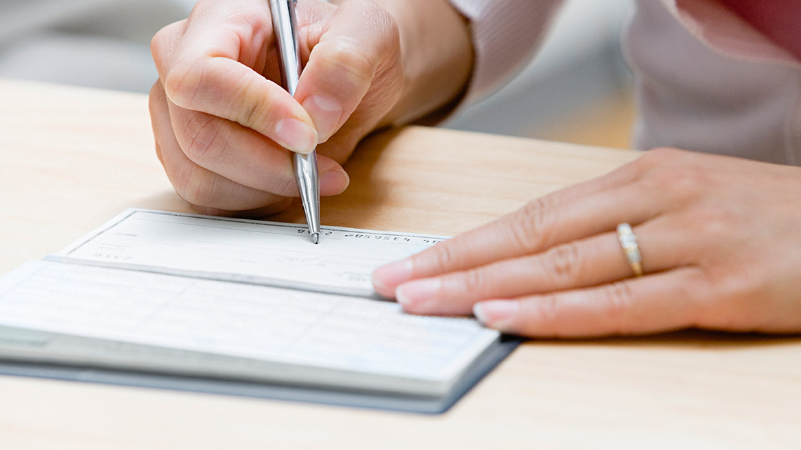 Person writing a check 